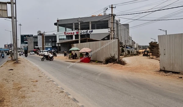 Wide angle perspective of the access gate vicinity and neighboring commercial establishments next to Sobha One Residences