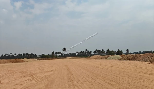 Expansive view of the cleared land preparation for Sobha One Residences with distant trees