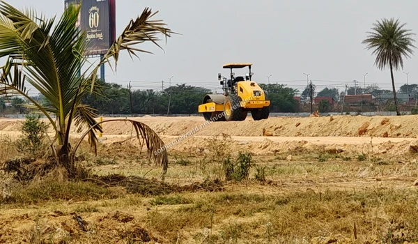 Multiple excavated earth mounds stored across the graded construction area of Sobha One Residences