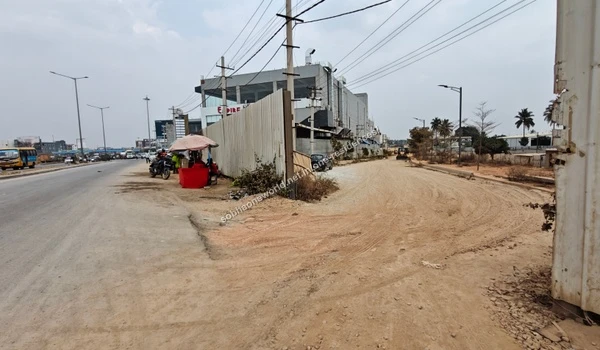 The junction point where the major highway meets the dedicated dirt access path for Sobha One Residences