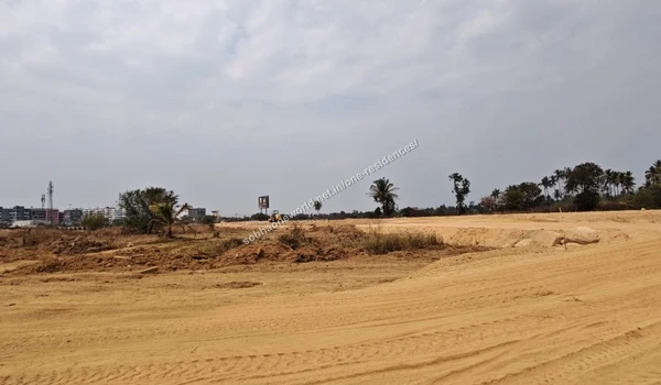 Cleared and graded dirt pathways curving towards the site perimeter at Sobha One Residences