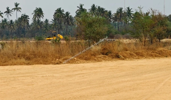Substantial mounds of reddish excavated soil positioned near a large preserved tree at Sobha One Residences