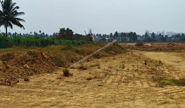 Substantial mounds of reddish excavated earth with preserved greenery in the background at Sobha One Residences