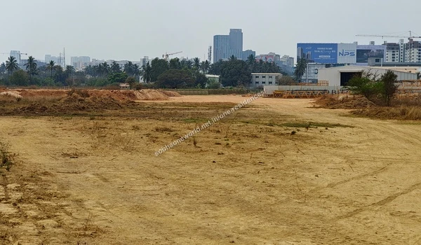 Sandy leveled terrain and internal pathways marked by tire tracks at the Sobha One Residences location