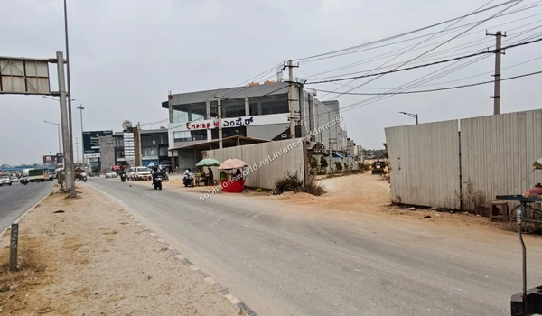 Construction barricades and site entrance clearing visible from the main street at Sobha One Residences