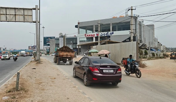 Local street vendors set up along the pathway adjacent to the prominent Empire commercial complex near Sobha One Residences