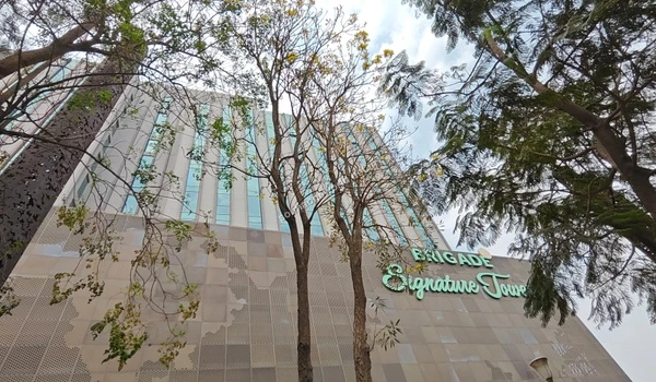 Wide streets framing the impressive glass facades of local business hubs neighboring Sobha One World