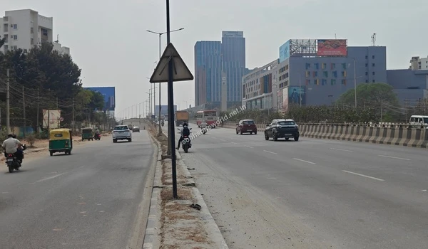 Wide perspective of the multilane highway leading towards the prominent commercial district near the Sobha One World project
