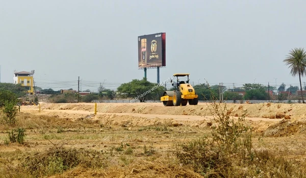 Heavy ground leveling and compaction activities taking place across the vast Sobha One World site with a prominent project advertising billboard visible in the backdrop.