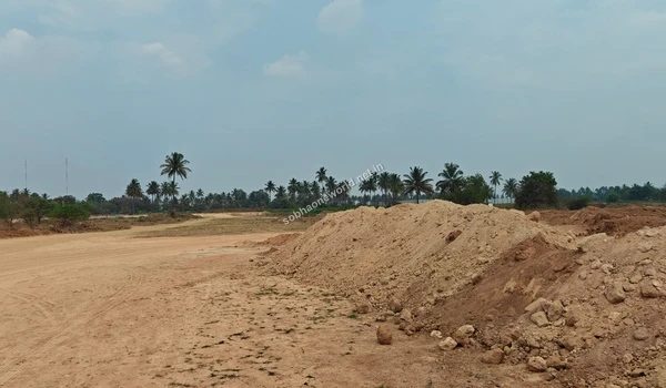 The scale of earthmoving at Sobha One World is visible in this long continuous mound of soil dividing the newly leveled sandy tracts.