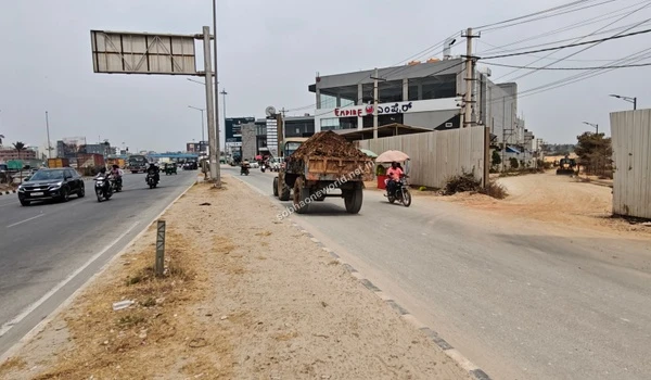 The designated development zone featuring protective fencing to separate the Sobha One World site from public access roads.