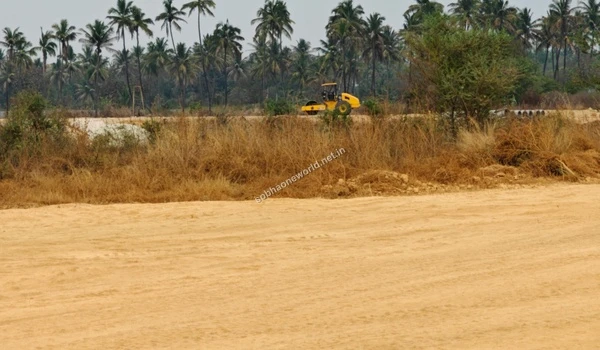 Heavy ground leveling activities taking place on the newly formed dirt tracks across the vast Sobha One World development lands perimeter.