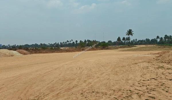Large collections of excavated multi-colored soil resting on the heavily tracked Sobha One World site grounds indicating deep excavation.