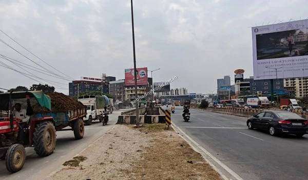 Wide view of the bustling highway corridor connecting to KR Puram at the Sobha One World development entrance