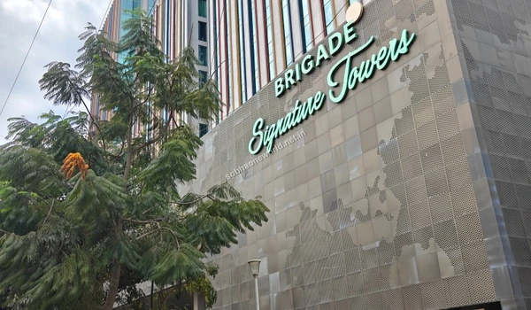 Upward view of the impressive corporate tower facade representing the massive office spaces available next to Sobha One World