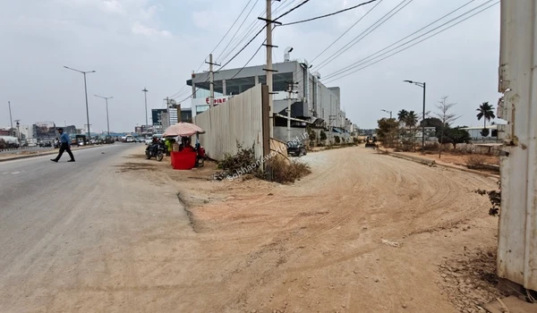 The inner unpaved access way leading deep into the Sobha One World construction area from the main public avenue.