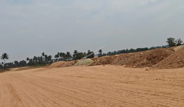 Expansive view of the Sobha One World land undergoing grading, featuring distinct heaps of red and lighter colored earth moved during site preparation.