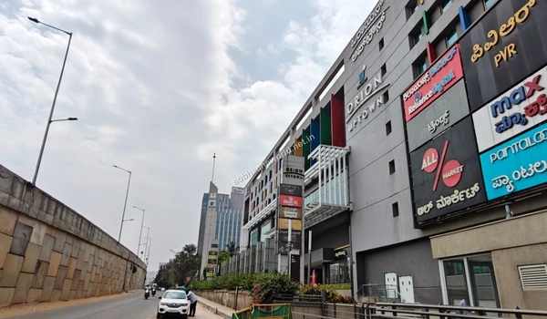 The towering structure of the local urban mall acting as a prime lifestyle and recreational landmark for families residing in Sobha One World.