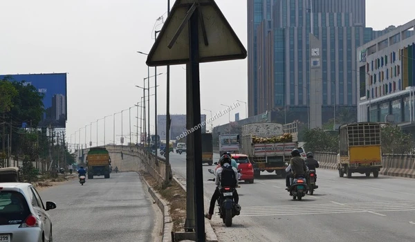 The main commuting route featuring the flyover entrance and urban landscape surrounding the Sobha One World project