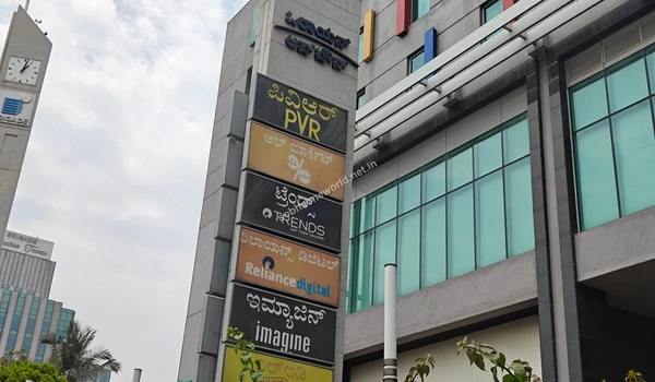 The towering directional pylon and branding signage indicating the presence of premium lifestyle amenities directly adjacent to Sobha One World.