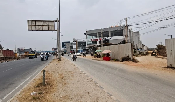 The neighborhood surrounding Sobha One World, featuring prominent commercial buildings located near the project access.