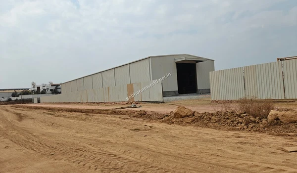 Side elevation view of the long temporary site office structure and terrain at the Sobha One World location