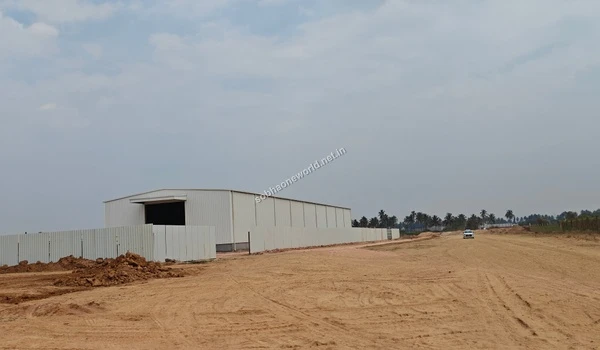 Frontal perspective of the temporary site office structure and white fencing at the Sobha One World development area