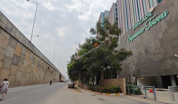 Modern corporate landscape of nearby IT parks showcasing the walkable work zones surrounding the Sobha One World project