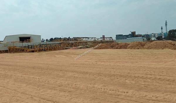 The primary staging sector of the Sobha One World lands showcasing temporary offices bordered by large heaps of moved earth.