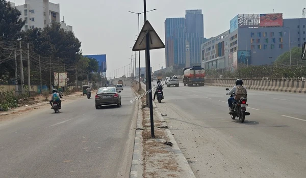 Wide access road leading towards the commercial hubs and the entrance of the Sobha One World property