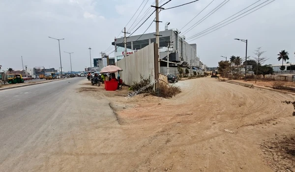 The boundary perimeter and adjacent unpaved access routes bordering the designated footprint of Sobha One World.