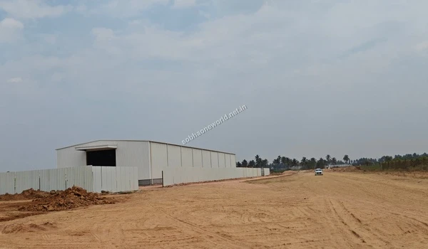 Setup of the temporary project office and boundary barricades at the expansive Sobha One World construction site