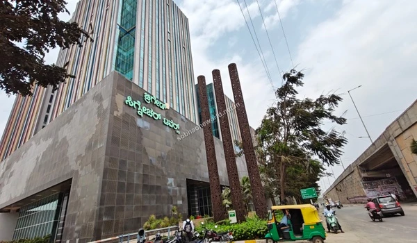 Large green corporate signage along the main road marking the entrance to major IT parks in the vicinity of Sobha One World