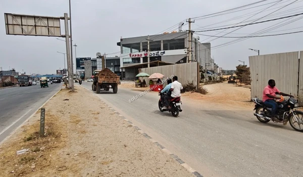 The evolving roadside landscape and infrastructural improvements happening adjacent to the Sobha One World campus.