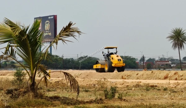 Sandy terrain pathway traversing the Sobha One World development site area.