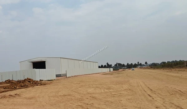 View approaching the ongoing temporary site office construction with white barricades at Sobha One World