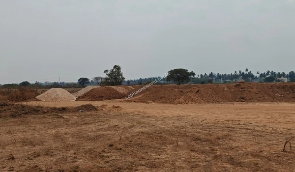 The altered topography of the Sobha One World project lands showing flat sandy tracts contrasted with large piles of excavated earth awaiting redistribution.