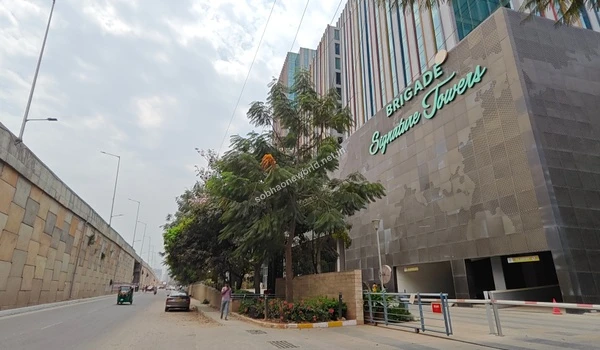 Street-level perspective of the sprawling IT campus gate and beautifully maintained business park landscape near Sobha One World