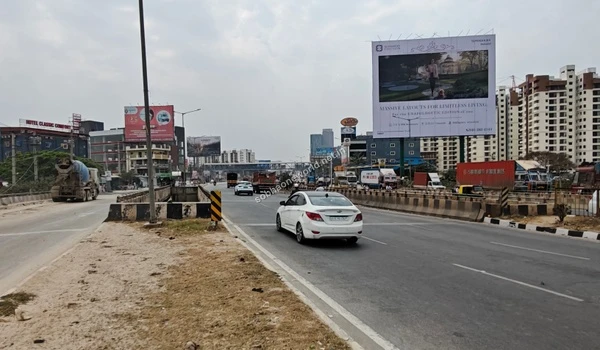 Expansive street perspective of the KR Puram bound road directly in front of the Sobha One World site
