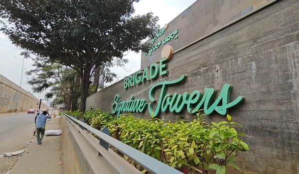 Wide street view revealing the grand entrance of major tech parks located just a short distance from Sobha One World