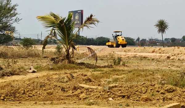 The active terrain modification phase at the Sobha One World site location showing flattened earth pathways passing by existing native vegetation.