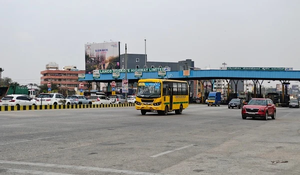 Evening view of the well-lit Hoskote Toll plaza highlighting safe night-time travel to Sobha One World