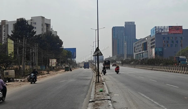 Extensive urban road network and overhead signage structures guiding towards the Sobha One World residential area